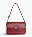 Elegant wine red leather shoulder bag featuring a minimalist silver chain buckle design - Red