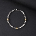 Detail of silver box chain with gold textured cylinders and lobster clasp on black leather - 5mm Square Box Chain With Gold Beads Bracelet / 21cm