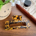 Classic oversized amber tortoiseshell acetate hair claw clip on a rustic wooden desk - Brown Tortoise Shell 13CM