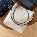 Detailed overhead view of striped, dotted, and denim fabric small crossbody bags on wood - Solid Beige