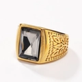 Detail of gold ring with large rectangular grey stone and engraved leaf patterns - Gold Mineral Black