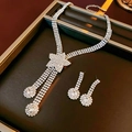 Detail of silver star necklace and earrings set with crystal tassels on velvet tray - Star Style / Silver