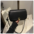 Detail of black flap crossbody bag with golden C-buckle and hand-knotted strap joints - Black
