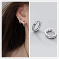 Silver hoop earrings with hollow Roman numeral design shown on model and close-up - Silver Roman Numerals Ear Buckle