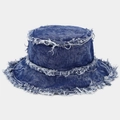 Close-up of blue washed denim bucket hat with frayed edges and textured twill fabric - Blue