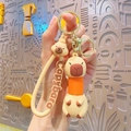 Capybara pop tube keychain with orange stretchable neck and silicone wrist strap - Pop Tube Capybara - Orange