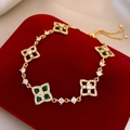Detail of adjustable gold heart bracelet with green gemstone on red velvet box - Bracelet - Gold - Green