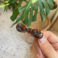 Detailed close-up of a tortoiseshell bow hair clip with gold Barrette La France lettering - Blue Tortoise