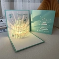 3D pop-up birthday card with glowing cyan cake sculpture and laser-cut BEST WISH - Spring Blue Cake+Music Yellow Light-Button