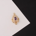 Close-up of gold-plated waterdrop connector with purple stone and zircon border - Purple