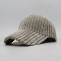 Close-up of thick striped corduroy fabric texture on a warm winter baseball cap - Gray