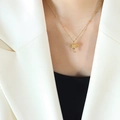 Minimalist gold elephant pendant necklace with a beaded chain worn by a model - Gold