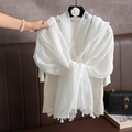 Elegant white linen cotton shawl with fringe details shown on a hanger for travel - White