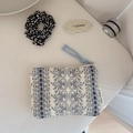 Detail of quilted floral cotton pouch with blue zipper pull and vintage lace patterns - White with Navy Floral