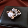 Detail of vintage flower ring with large central pearl on elegant black leather box - Gold White Pearl Flower Style