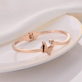 Rose gold open bangle featuring a frosted butterfly charm and sparkling crystal accent - Butterfly Bangle / Rose Gold