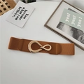 Elastic brown waist belt for women with textured golden oval buckle on white surface - Camel