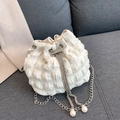 White pleated fabric bucket bag with silver chain strap and pearl charms on grey sofa - Off White