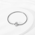 Detailed close-up of a silver snake chain bracelet with a sparkling crown-shaped clasp - Steel Color Crown Clasp