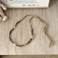 Detail of bohemian hand-woven hemp belt featuring natural wooden beads and white shells - Hemp Rope Shell Coffee Wood Bead - 134cm