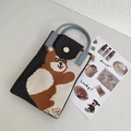 Detail of a mini knitted crossbody bag with a brown bear pattern and contrast colors - Grey Hugging Bear