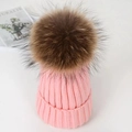 Chunky pink cable knit beanie featuring a large fluffy brown fur pompom on top - Pink