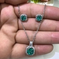 Macro shot of silver necklace and earrings set with green square emerald-cut gemstones - Ice Green
