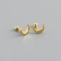 Macro shot of minimalist gold crescent moon stud earrings with screw ball backs - Gold