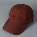 Detail view of burgundy quick-dry baseball cap with embroidered explosive text - M (56-58cm) / Red