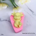 Pink silicone mold with yellow 3D deer figurine for DIY cake decorating and crafts - Curled-up Sleepy Fawn