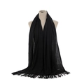 Detailed view of the fine fringe texture and soft cashmere fabric of the black scarf - Black
