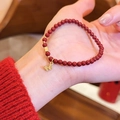 Close-up detail of a red agate beaded bracelet with an elegant gold butterfly charm on wrist. - Gold Butterfly Style (5#) / Gold-Red