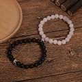Magnetische koppel armbanden met roze kristal, zwarte onyx kralen en zilveren kronen - Mat Zwart & Rozenkwarts Met Kroon