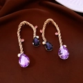 Detail of vintage gold twisted earrings with large pear-shaped purple rhinestones - Twisted Rope Curved Purple Gemstone Style