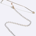 Golden eyewear chain with 5mm opal beads and silicone loops on white background - Gold