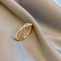 Detail of gold-plated crisscross ring with micro pearls and sparkling zircon stones - Style G-Streamline Cross Pearl Zircon