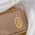 Gold Virgin Mary oval necklace with floral crystal accents on a beige jewelry box - Virgin Mary Oval Floral Rhinestone Style (E146)