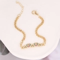 Detailed view of a gold heart charm bracelet with colorful zircon stones on stone texture - Five Heart Pendants (20#)