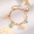 Gold Bohemian beach bracelet with sea shells, starfish charms and pearls on sand - KC Gold Heart of the Ocean Bracelet (5735)