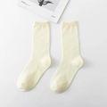 Pair of light yellow cotton crew socks featuring a ribbed knit design on a white background - Off White