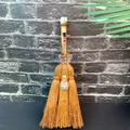 Detailed view of handmade witch broom with natural crystals, solar charm, and butterfly deco - Fluorite + Butterfly + Sun