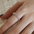 Elegant gold ring with pink oval gemstones on a cream lace background for women - Adjustable Open / Gold Pink Oval Stone Band Style (J5540)