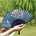 Classic dark blue folding fan with pink cherry blossoms and black silk tassel - Competing Flowers