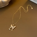 Elegant gold butterfly pendant necklace with zircon paving on brown leather background - Gold