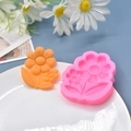 Pink silicone flower mold for fondant and clay with orange floral finished pieces - Default