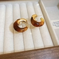 Detail of amber resin C-shape hoop earrings with gold metal studs on beige velvet - C-Shape Geometric Style / Coffee Resin (Silver Pin)
