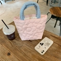 Detailed view of quilted flower pattern on the pink and blue padded mommy handbag - Pink
