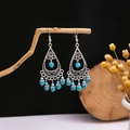 Close-up of bohemian silver drop earrings with blue turquoise beads on a rustic branch - E1429-2/Teardrop Hollow Six Bead Tassel