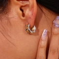 Close-up of two-tone gear edge hoop earrings in gold and silver on a model ear - Two Colors