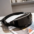 Glossy black waist bag with silver zipper and adjustable strap on marble table - Black